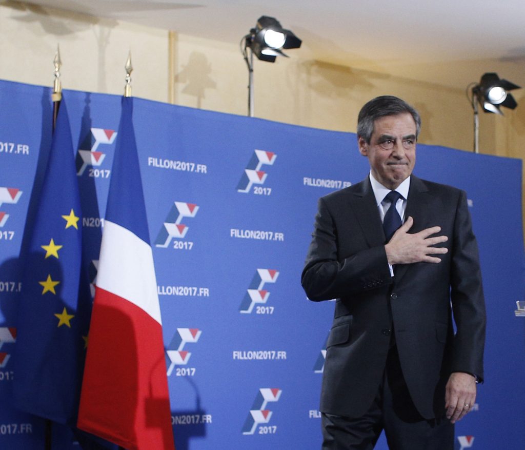 Francois Fillon acknowledges applauses before delivering a speech after the official announcement of results in the conservative party's national primary election in Paris, France, Sunday, Nov. 27, 2016 in Paris. Fillon has declared victory in France's first-ever conservative presidential primary, beating a more moderate rival who had warned of encroaching populism. (AP Photo/Thibault Camus)